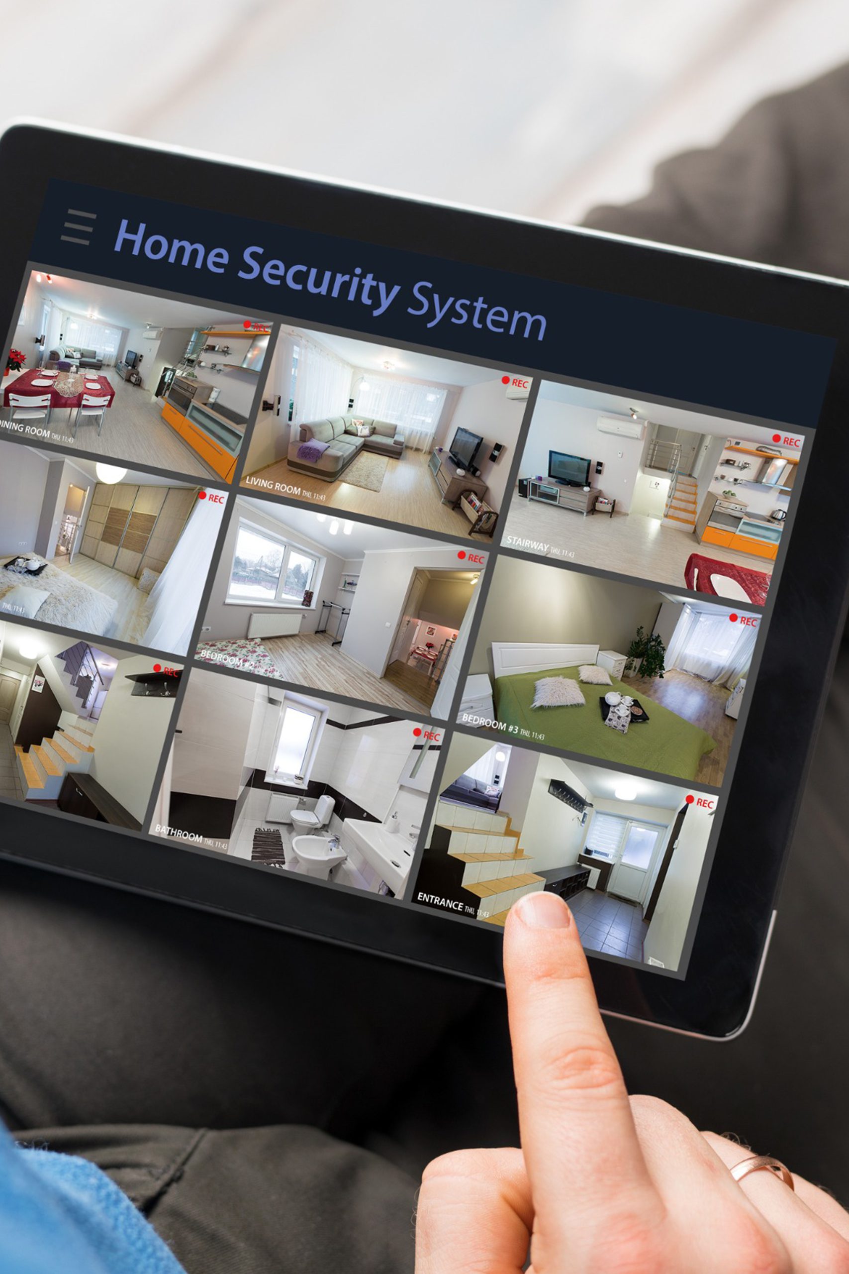 Man looking at home security cameras on tablet Man looking at home security cameras on tablet